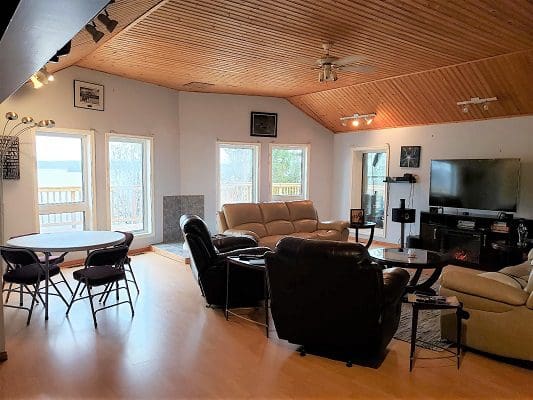 A living room with couches and a fireplace.