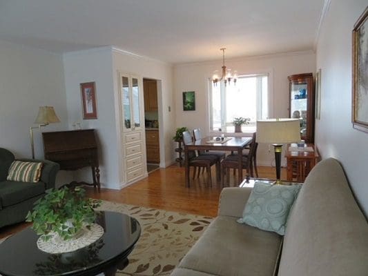A living room with a dining table and chairs.