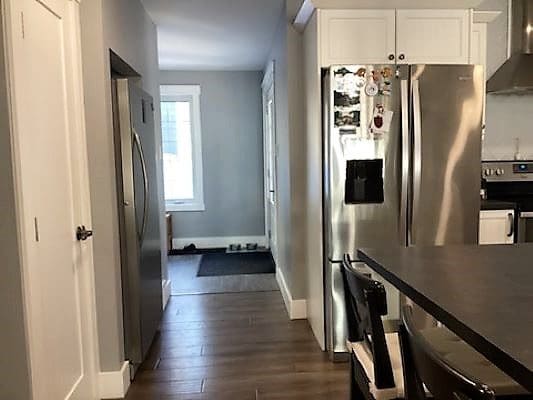 A kitchen with stainless steel appliances and hardwood floors.