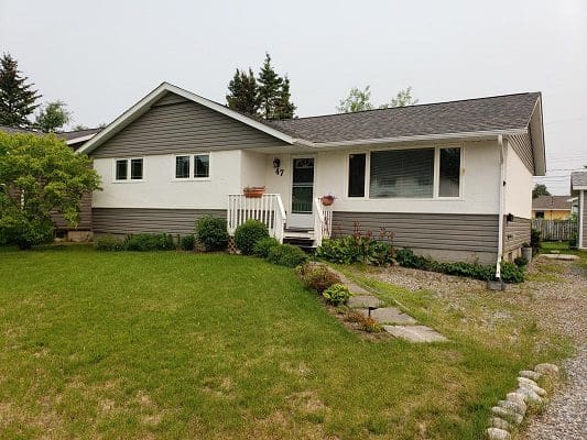 A house with a lawn and grass in front of it.