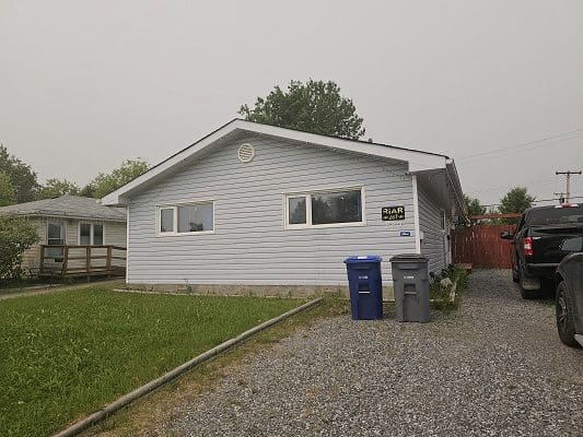 A house with a car parked in front of it.