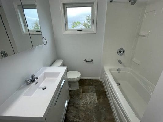 A white bathroom with a toilet and sink.