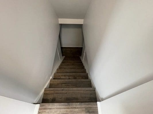 A stairway leading up to a room in a house.