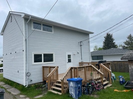 A house with a deck and a small yard.