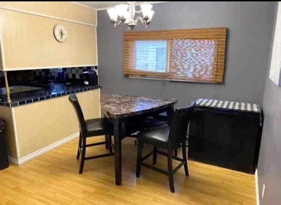 A small kitchen with a table and chairs.