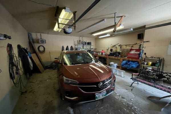 Brown SUV in cluttered garage.