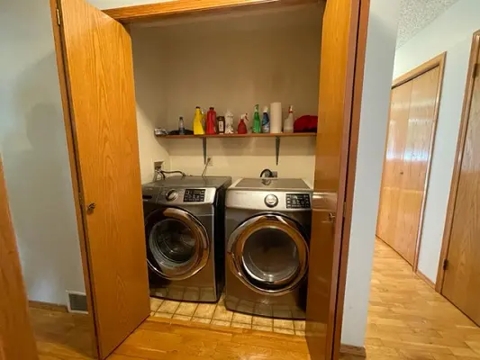 A laundry room with two washers and dryers.