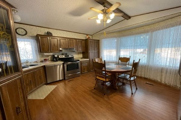 Kitchen with dining area and wood floors.