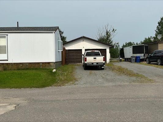 Truck parked in front of double garage.