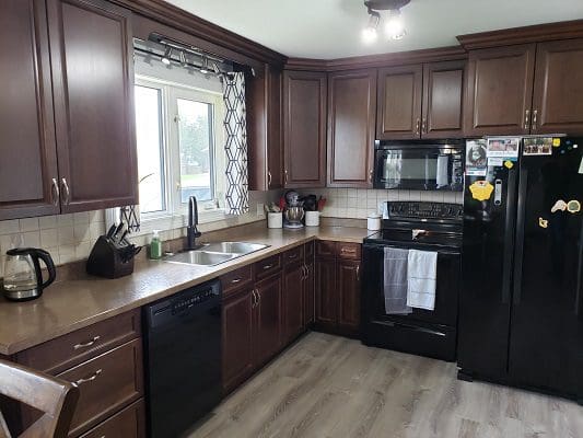 Brown kitchen with appliances and window.