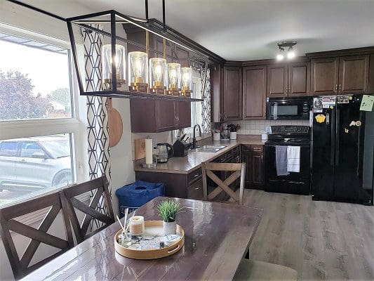 Modern kitchen with island and chandelier.