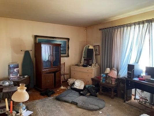 Messy room with furniture and computer.