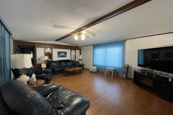 Living room with leather furniture and TV.