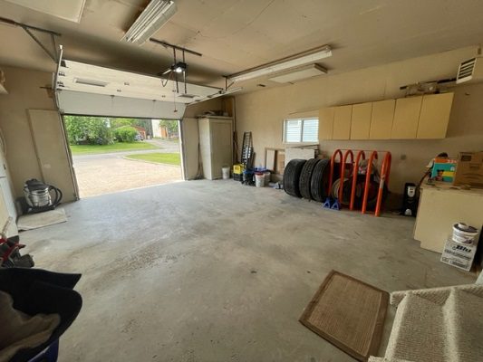 A garage with a lot of tires and tools.