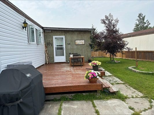 Mobile home deck with patio furniture.