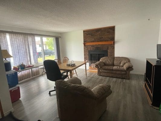 Living room with couch and dining table.
