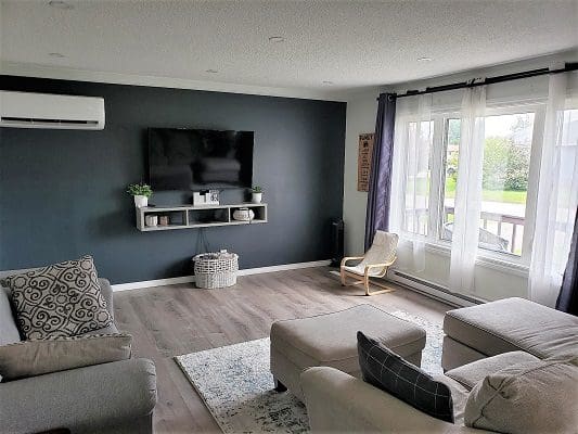 Living room with sectional sofa and TV.
