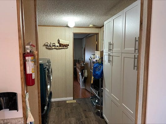 Laundry room with washer, dryer, and cabinets.