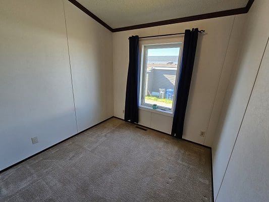 Empty bedroom with window view.