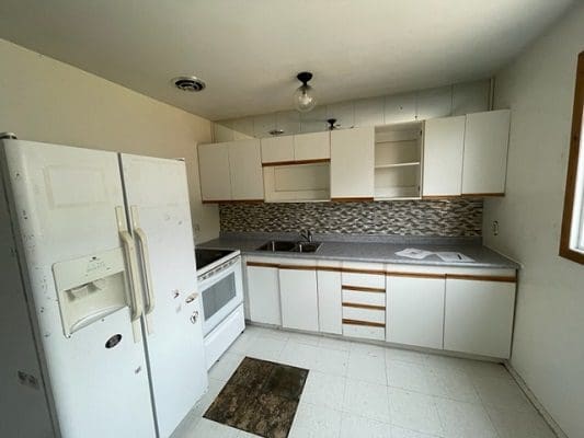 White kitchen with appliances and cabinets.