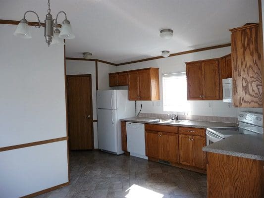 Kitchen with wood cabinets and appliances.