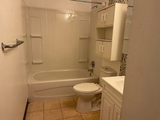 Small bathroom with tub and shower.
