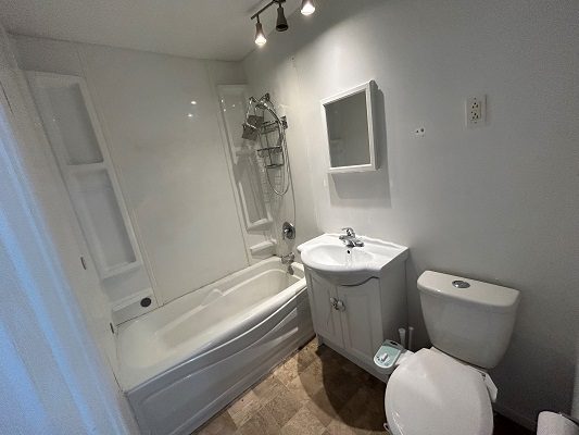 A white bathroom with a toilet and sink.