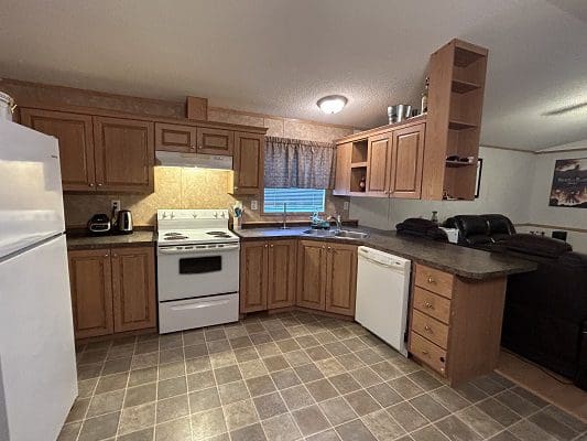Mobile home kitchen with wood cabinets.