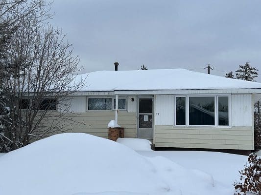 Snow-covered ranch house in winter.