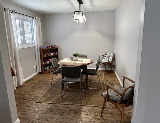 Dining room with hardwood floor and table.