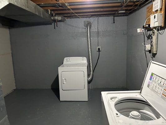 Basement laundry room with washer and dryer.