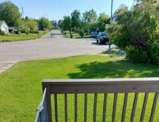 Deck view of suburban street scene.