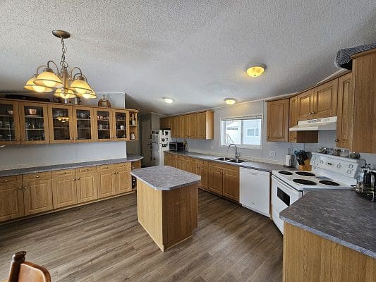 Spacious kitchen with island and wood cabinets.