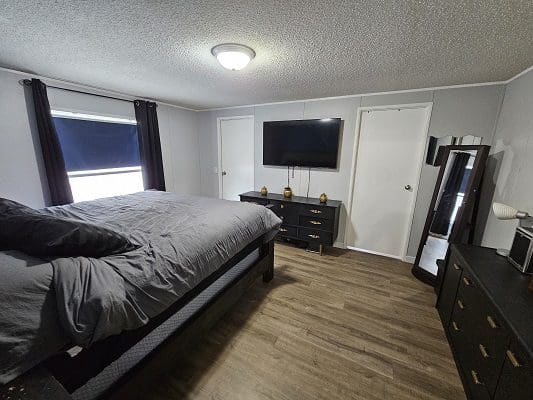 Master bedroom with bed and TV.