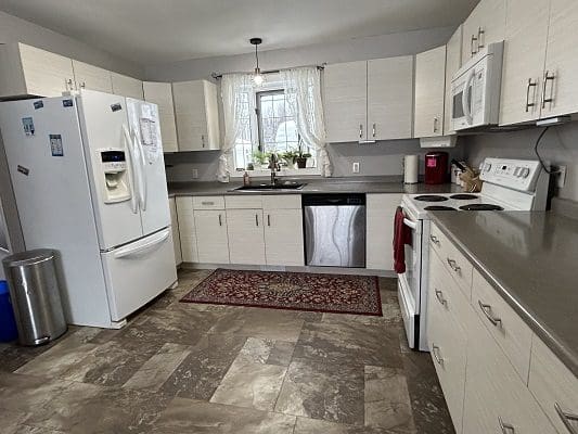 Kitchen with white cabinets and appliances.