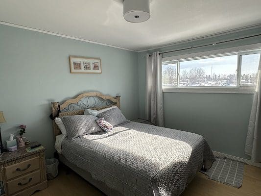 Bedroom with bed and window view.