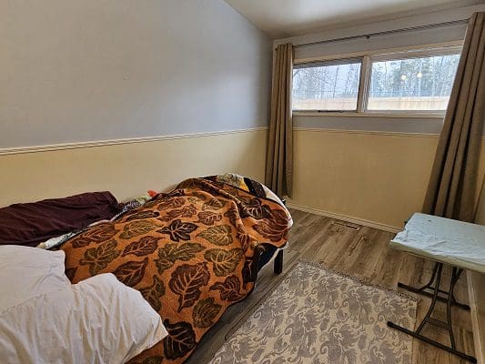Bedroom with bed and small table.