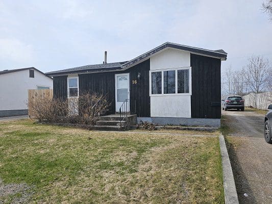 Dark-sided house with white trim.