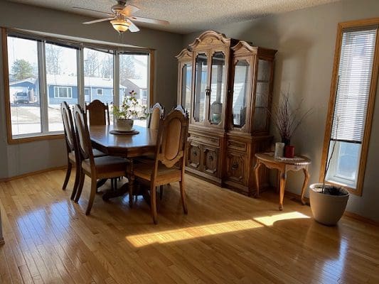 Dining room with wood floors and hutch.