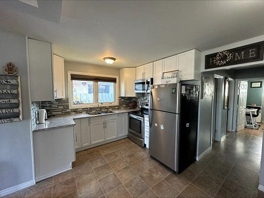 Bright kitchen with stainless steel appliances.