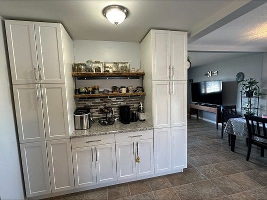 White kitchen cabinets with coffee bar.