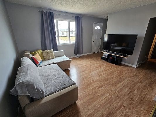 Living room with sectional sofa and TV.