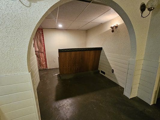 Basement bar area with wood counter.