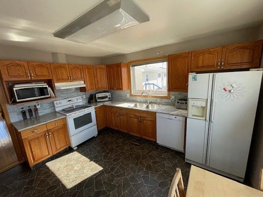 Kitchen with wood cabinets and appliances.