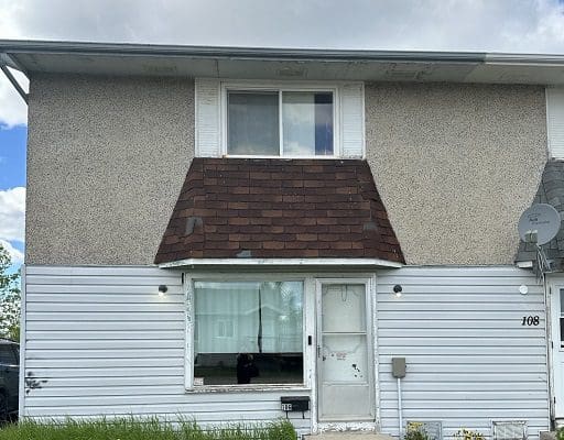 Here's an alt tag for the image: Two-story house, number 108.
