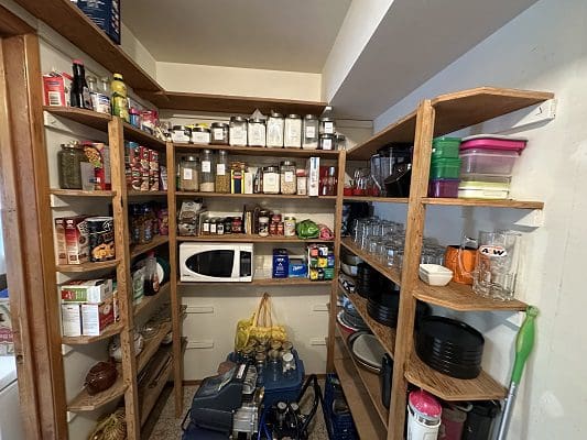 Well-stocked pantry with shelves of food.
