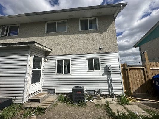 Back of house with grey siding.