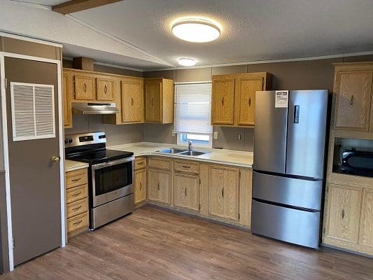 Mobile home kitchen with stainless steel appliances.