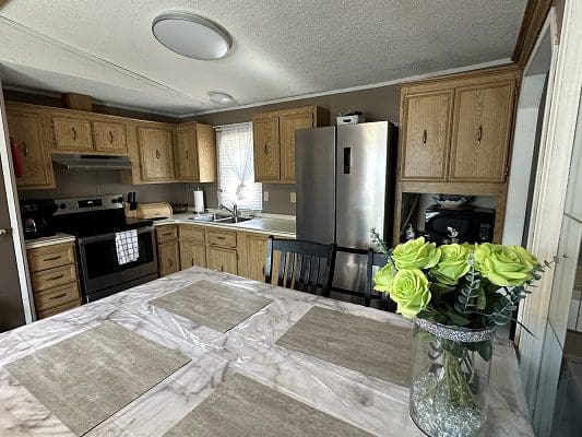 Mobile home kitchen with stainless appliances.