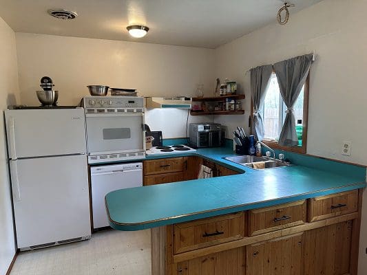Teal countertop in a small kitchen.